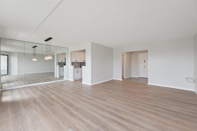 400 High Point Dr Unit 313, Hartsdale, NY 10530 - unfurnished living room with light wood finished floors and baseboards