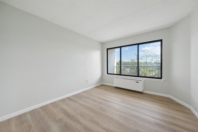400 High Point Dr Unit 313, Hartsdale, NY 10530 - unfurnished room with radiator, light wood finished floors, and baseboards