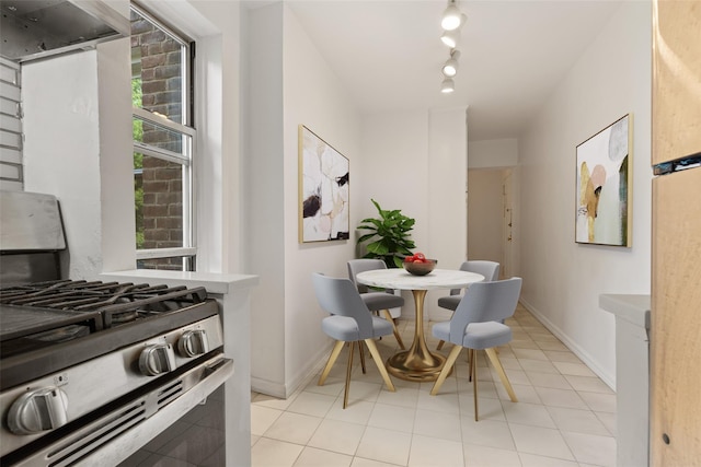 dining room with baseboards and light tile patterned floors