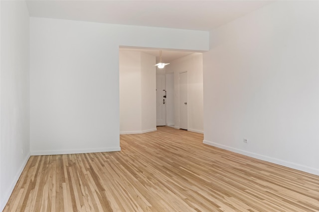 unfurnished room with light wood-style floors and baseboards
