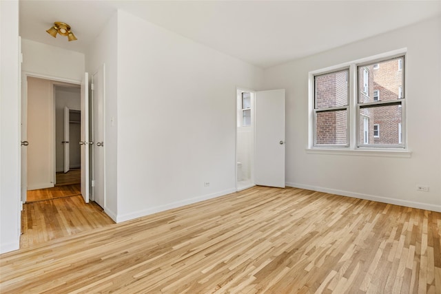 unfurnished bedroom with light wood-type flooring and baseboards