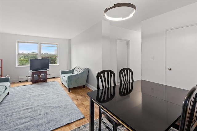 5500 Fieldston Rd Unit 77, Bronx, NY 10471 - dining room featuring a chandelier, a baseboard heating unit, and baseboards