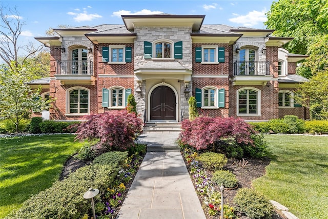 7 Beverly Rd, Kensington, NY 11021 - view of front of property with a balcony, brick siding, a front lawn, and entry steps