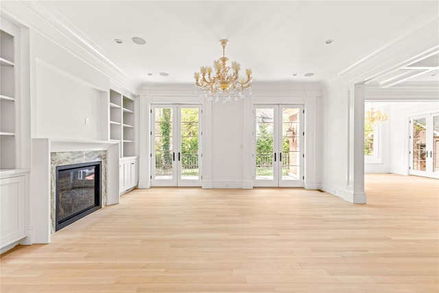 7 Beverly Rd, Kensington, NY 11021 - unfurnished living room featuring french doors, a chandelier, ornamental molding, and a high end fireplace