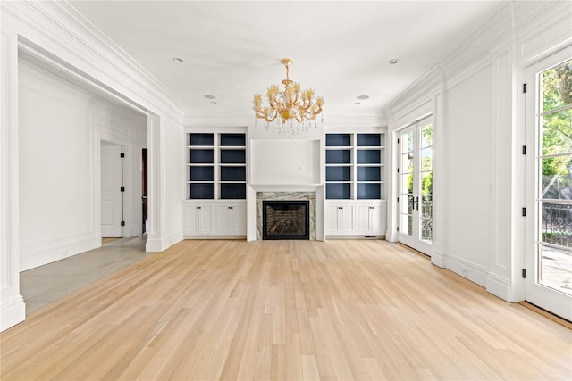7 Beverly Rd, Kensington, NY 11021 - unfurnished living room with light wood-style floors, ornamental molding, healthy amount of natural light, a chandelier, and a fireplace