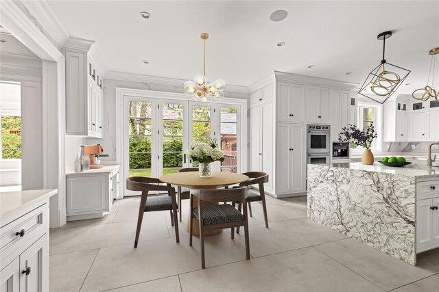 7 Beverly Rd, Kensington, NY 11021 - dining space with a chandelier, healthy amount of natural light, ornamental molding, and light tile patterned floors