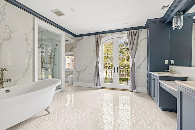 7 Beverly Rd, Kensington, NY 11021 - full bath with french doors, vanity, a freestanding bath, and crown molding