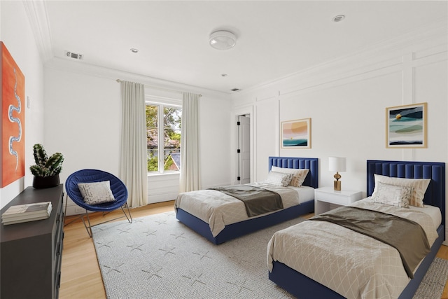 7 Beverly Rd, Kensington, NY 11021 - bedroom featuring crown molding and light wood-style flooring