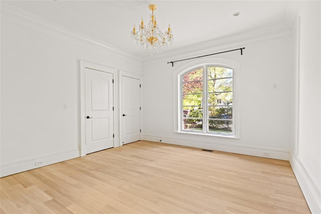 7 Beverly Rd, Kensington, NY 11021 - unfurnished room featuring a chandelier, light wood-style floors, ornamental molding, and baseboards