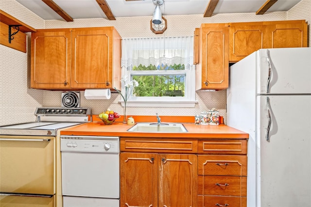 63 Lexington Dr, Croton-On-Hudson, NY 10520 - kitchen with white appliances, a sink, light countertops, brown cabinets, and beamed ceiling
