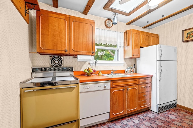 63 Lexington Dr, Croton-On-Hudson, NY 10520 - kitchen with white appliances, wallpapered walls, a sink, brick patterned flooring, and light countertops