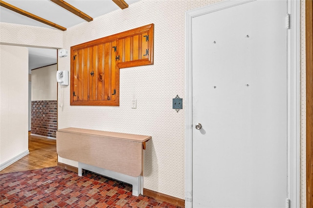 63 Lexington Dr, Croton-On-Hudson, NY 10520 - hallway with wallpapered walls, brick patterned flooring, and baseboards
