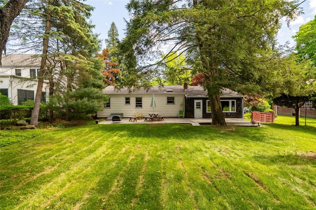 63 Lexington Dr, Croton-On-Hudson, NY 10520 - rear view of property featuring a lawn and a patio
