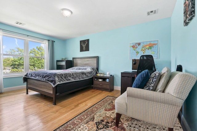 bedroom featuring baseboards and light wood-style flooring
