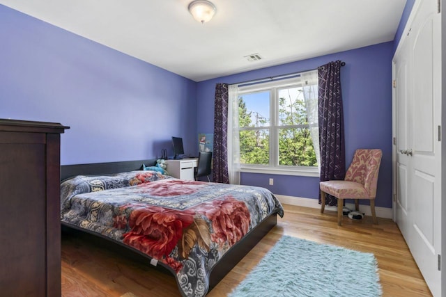 bedroom featuring wood finished floors and baseboards