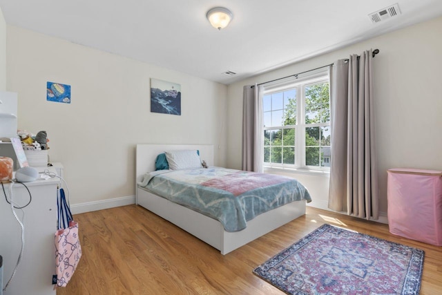 bedroom featuring wood finished floors and baseboards