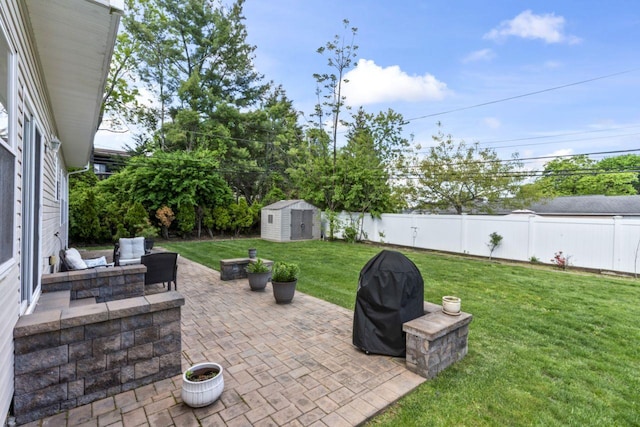 view of patio featuring a storage shed, an outbuilding, and area for grilling