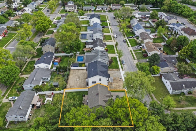 aerial view of property and surrounding area featuring nearby suburban area and property parcel outlined
