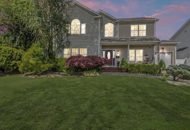 traditional home with an attached garage and a yard