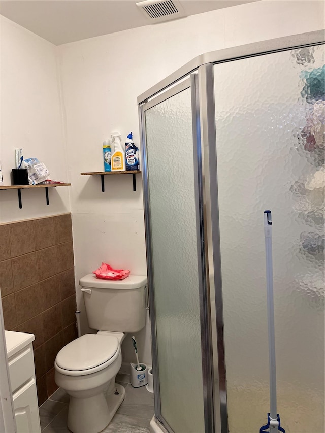 11 Acorn Ln, Stony Brook, NY 11790 - bathroom featuring a shower stall, toilet, vanity, tile walls, and tile patterned flooring