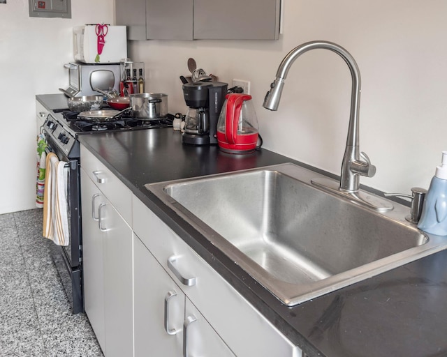 160 Cabrini Blvd Unit 62, New York Manhattan, NY 10033 - kitchen featuring a sink, gas stove, dark countertops, white cabinets, and electric panel
