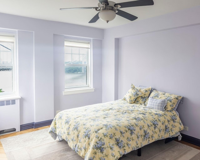 160 Cabrini Blvd Unit 62, New York Manhattan, NY 10033 - bedroom featuring radiator, wood finished floors, a ceiling fan, and baseboards
