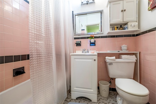 100 S Ocean Ave Unit 2E, Freeport, NY 11520 - bathroom with tile walls, toilet, vanity, and shower / tub combo