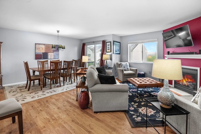 1303 Eagles Ridge Rd, Brewster, NY 10509 - living area featuring wood finished floors and a warm lit fireplace