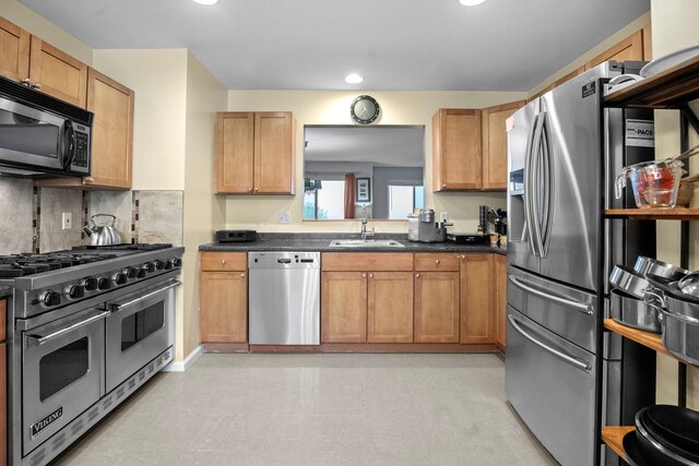 1303 Eagles Ridge Rd, Brewster, NY 10509 - kitchen featuring stainless steel appliances, a sink, dark countertops, recessed lighting, and decorative backsplash