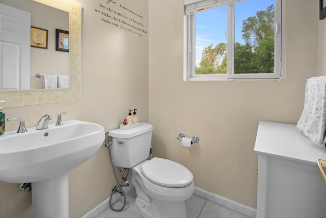 1303 Eagles Ridge Rd, Brewster, NY 10509 - half bathroom featuring baseboards, tile patterned flooring, toilet, and a sink