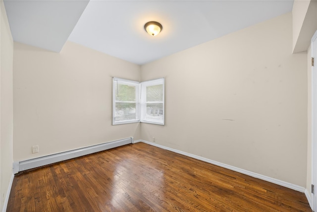 175 N Columbus Ave, Freeport, NY 11520 - unfurnished room featuring a baseboard heating unit, wood finished floors, and baseboards