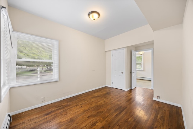 175 N Columbus Ave, Freeport, NY 11520 - spare room with a baseboard heating unit, wood finished floors, and baseboards