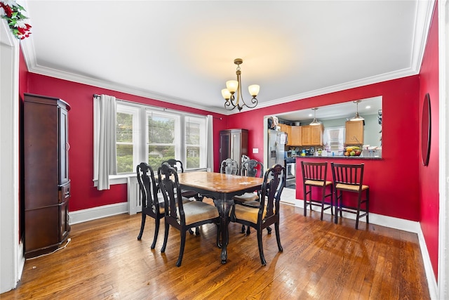 175 N Columbus Ave, Freeport, NY 11520 - dining space with a chandelier, wood finished floors, ornamental molding, and baseboards