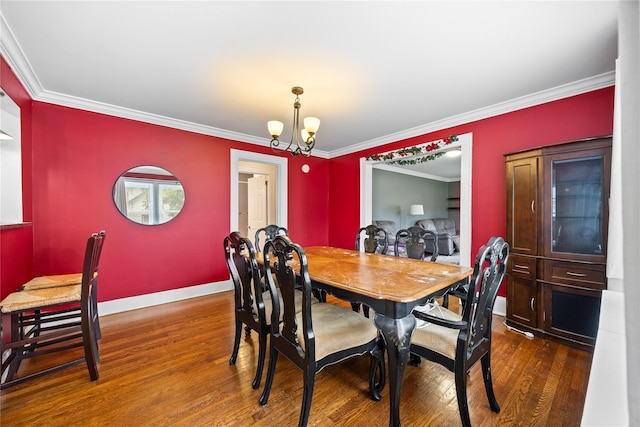 175 N Columbus Ave, Freeport, NY 11520 - dining room with dark wood finished floors, baseboards, a chandelier, and ornamental molding