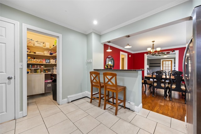 175 N Columbus Ave, Freeport, NY 11520 - kitchen featuring a chandelier, ornamental molding, light tile patterned flooring, baseboards, and freestanding refrigerator