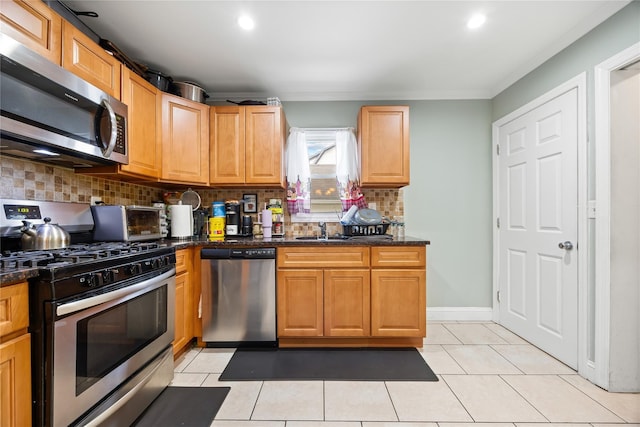 175 N Columbus Ave, Freeport, NY 11520 - kitchen featuring appliances with stainless steel finishes, ornamental molding, a sink, decorative backsplash, and light tile patterned floors