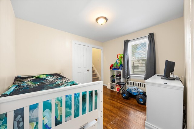 175 N Columbus Ave, Freeport, NY 11520 - bedroom featuring radiator and wood finished floors
