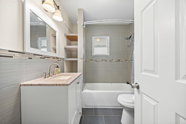 175 N Columbus Ave, Freeport, NY 11520 - bathroom featuring toilet, vanity, tile patterned flooring, shower / bathtub combination, and tile walls