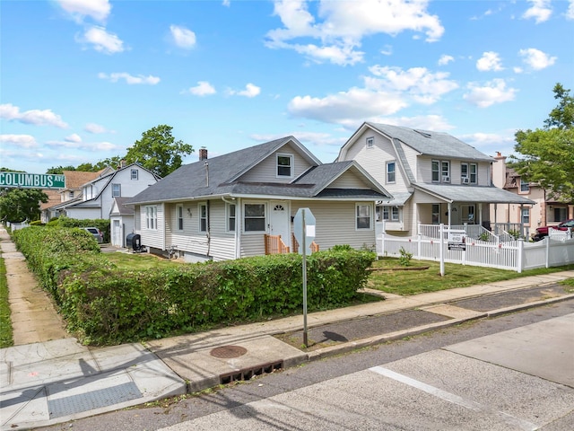 175 N Columbus Ave, Freeport, NY 11520 - view of front of home with roof with shingles, a porch, and a residential view