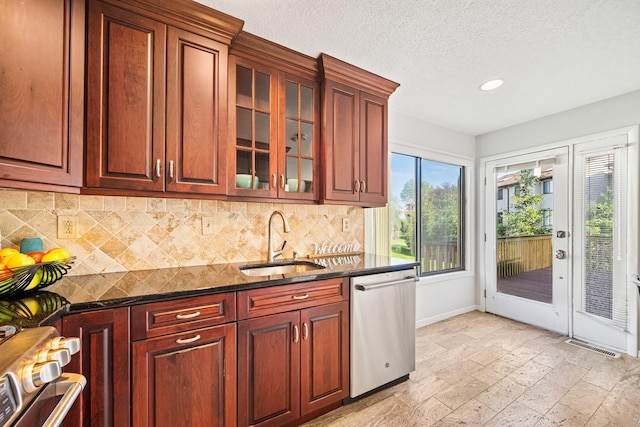 kitchen featuring stainless steel dishwasher, a sink, decorative backsplash, range, and recessed lighting
