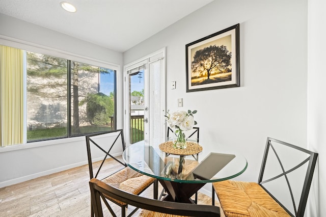 dining area featuring light wood finished floors, baseboards, and recessed lighting