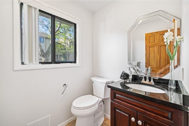 bathroom with toilet, baseboards, and vanity