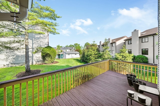 wooden terrace with a residential view and a lawn