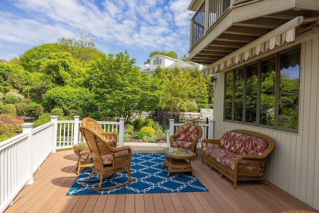wooden terrace featuring fence and an outdoor hangout area