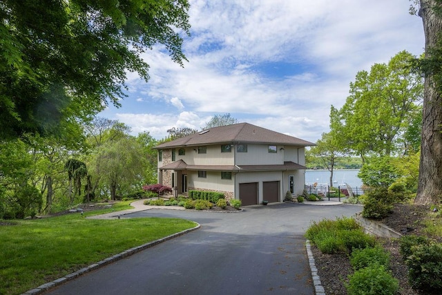 view of front facade with an attached garage, driveway, and a front yard