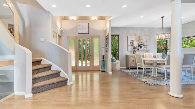 12 Sunset Path, Port Jefferson, NY 11777 - entrance foyer featuring wood finished floors, baseboards, recessed lighting, stairway, and a chandelier