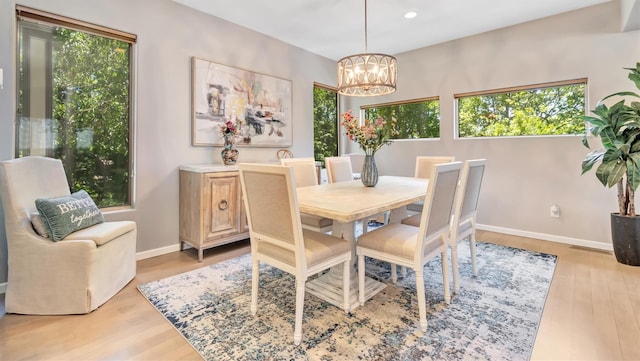 12 Sunset Path, Port Jefferson, NY 11777 - dining area featuring healthy amount of natural light, a chandelier, light wood-style floors, and recessed lighting