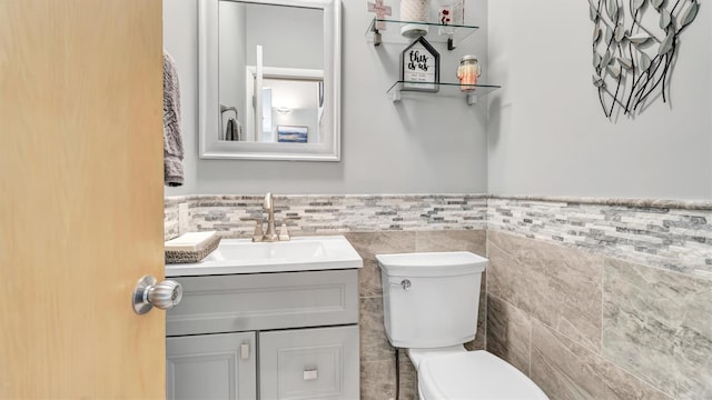 12 Sunset Path, Port Jefferson, NY 11777 - half bathroom featuring tile walls, a wainscoted wall, toilet, and vanity