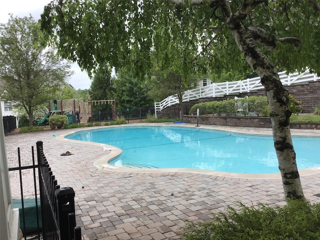 view of pool with fence and a patio