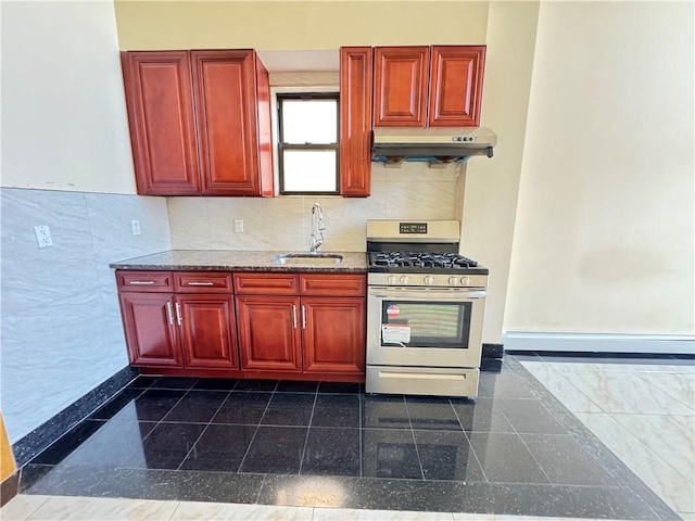 kitchen featuring gas range, a sink, under cabinet range hood, dark brown cabinets, and granite floors